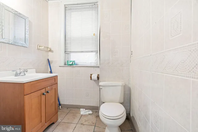 a bathroom with a sink toilet and window