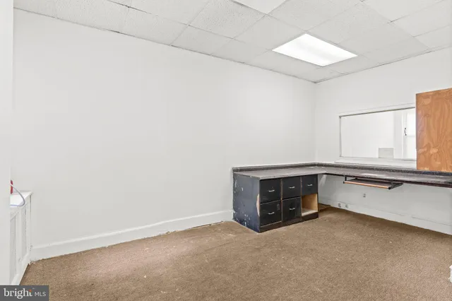 a room with a table and a fireplace