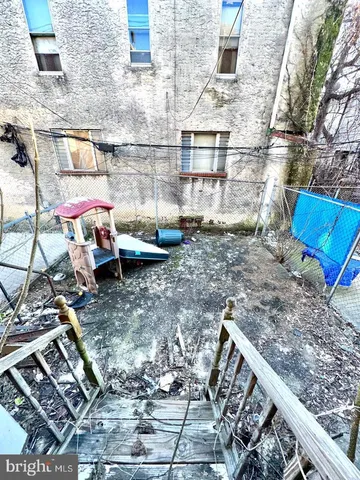 a view of a backyard with sitting area