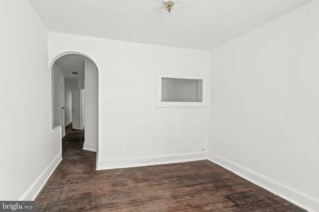 an empty room with wooden floor and closet