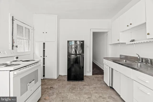 a kitchen with stainless steel appliances granite countertop a refrigerator and a stove