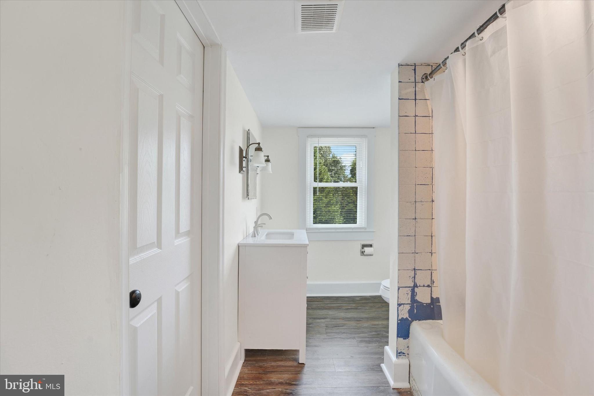15 North Walnut Street Rising Sun, MD 21911 - Photo 28 of 43 a bathroom with a bathtub a sink and a window