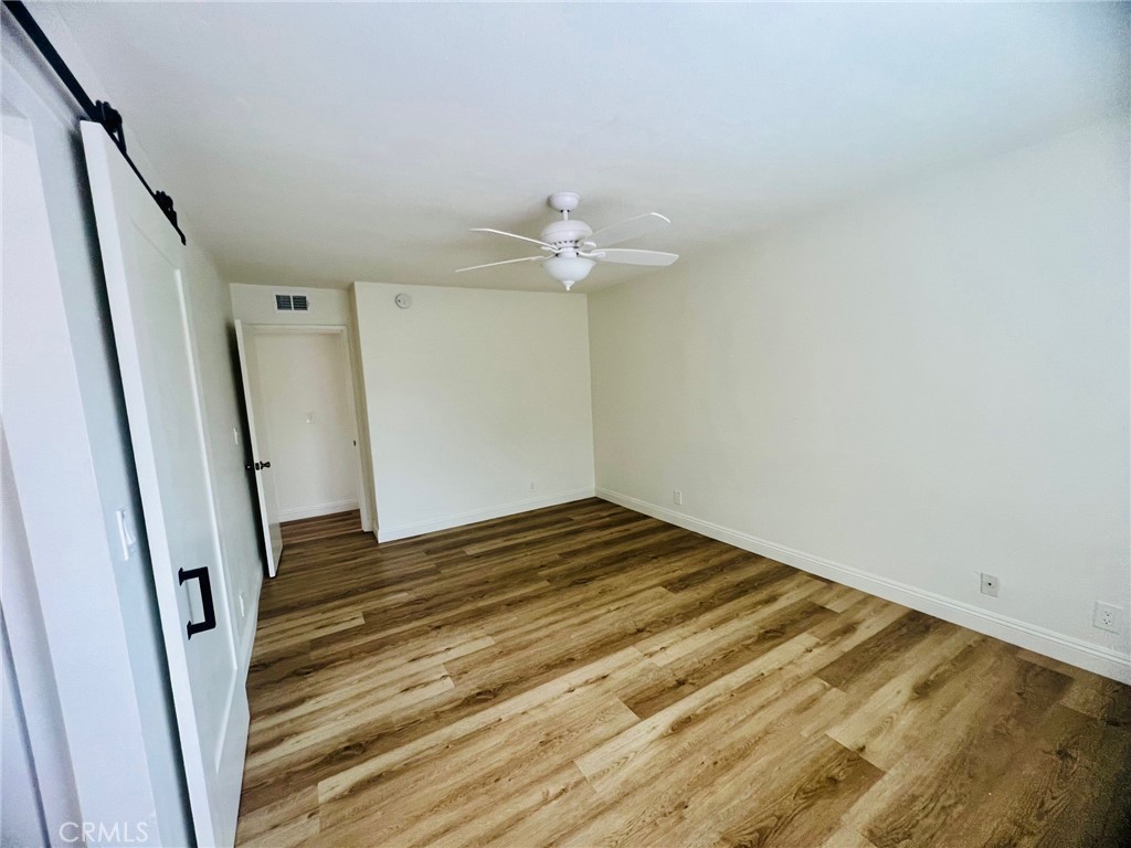 10801 Pine Street Los Alamitos, CA 90720 - Photo 18 of 24 a view of a room with wooden floor and ceiling fan