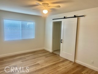 10801 Pine Street Los Alamitos, CA 90720 - Photo 19 of 24 a view of an empty room with wooden floor and a window