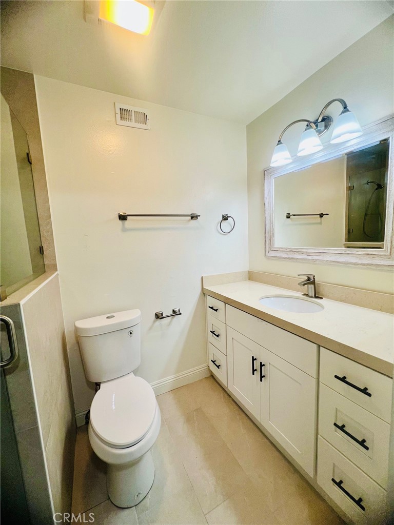 10801 Pine Street Los Alamitos, CA 90720 - Photo 20 of 24 a bathroom with a double vanity sink mirror and toilet