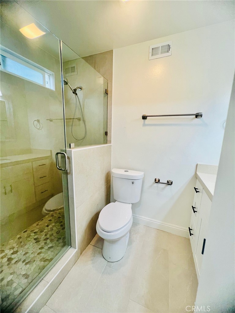 10801 Pine Street Los Alamitos, CA 90720 - Photo 21 of 24 a bathroom with a toilet and a shower