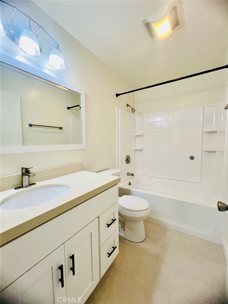10801 Pine Street Los Alamitos, CA 90720 - Photo 22 of 24 a bathroom with a sink a toilet and shower