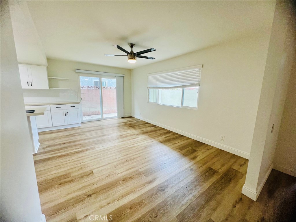 10801 Pine Street Los Alamitos, CA 90720 - Photo 3 of 24 a view of empty room with wooden floor and fan