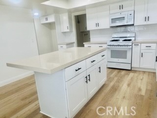 10801 Pine Street Los Alamitos, CA 90720 - Photo 5 of 24 a kitchen with cabinets and white appliances
