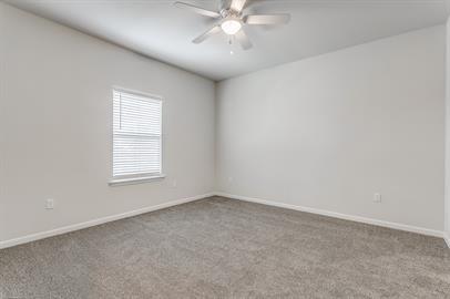 2407 North Hickory Street Sherman, TX 75092 - Photo 6 of 9 an empty room with a window and a fan