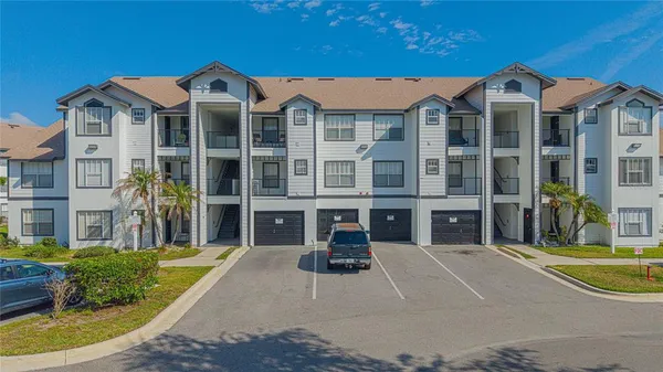a front view of a residential apartment building with a yard