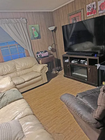 a bedroom with a bed and a television
