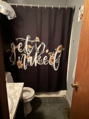 a bathroom with a toilet and shower