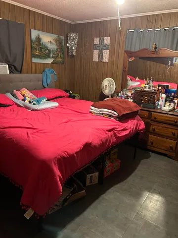 a bedroom with bed and window