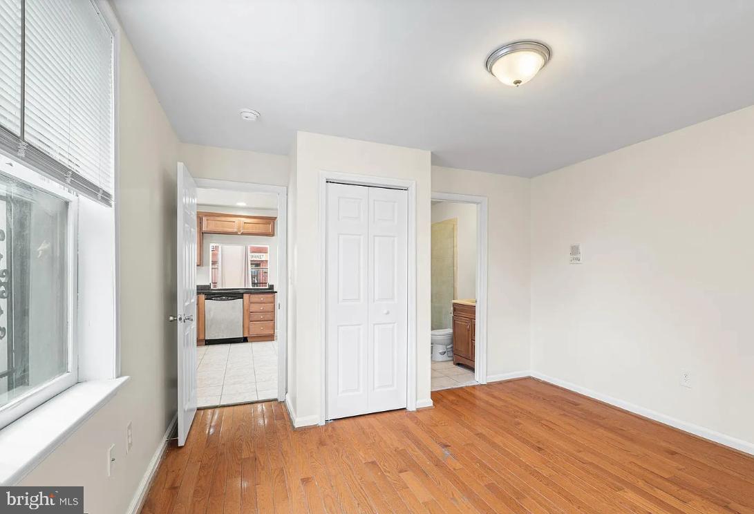 1401 Druid Hill Avenue, Unit A Baltimore, MD 21217 - Photo 10 of 17 a big room with wooden floor and a bathroom