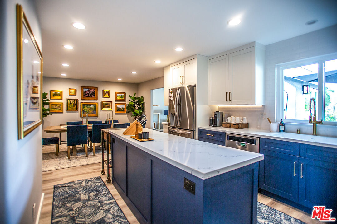 137 Main Street Los Alamos, CA 93440 - Photo 12 of 52 a kitchen with stainless steel appliances granite countertop a sink stove and refrigerator