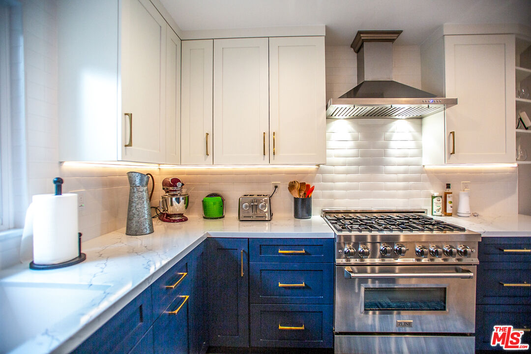 137 Main Street Los Alamos, CA 93440 - Photo 13 of 52 a kitchen with granite countertop a stove and a sink