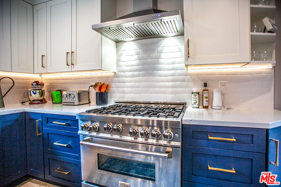 137 Main Street Los Alamos, CA 93440 - Photo 14 of 52 a kitchen with a stove and cabinets
