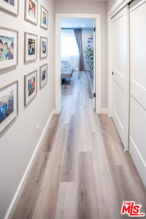 137 Main Street Los Alamos, CA 93440 - Photo 28 of 52 a view of a hallway with wooden floor and furniture