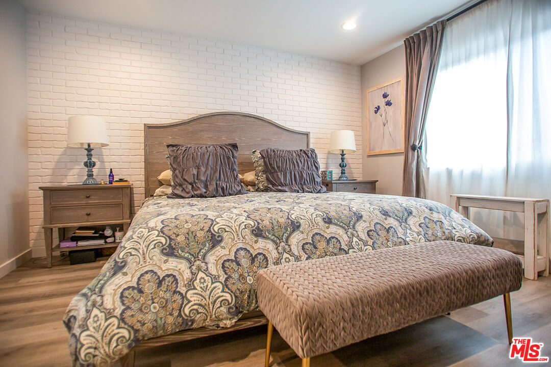 137 Main Street Los Alamos, CA 93440 - Photo 29 of 52 a large bedroom with a bed and wooden floor