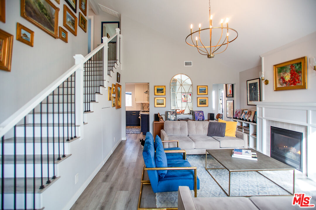 137 Main Street Los Alamos, CA 93440 - Photo 3 of 52 a living room with fireplace furniture and a wooden floor