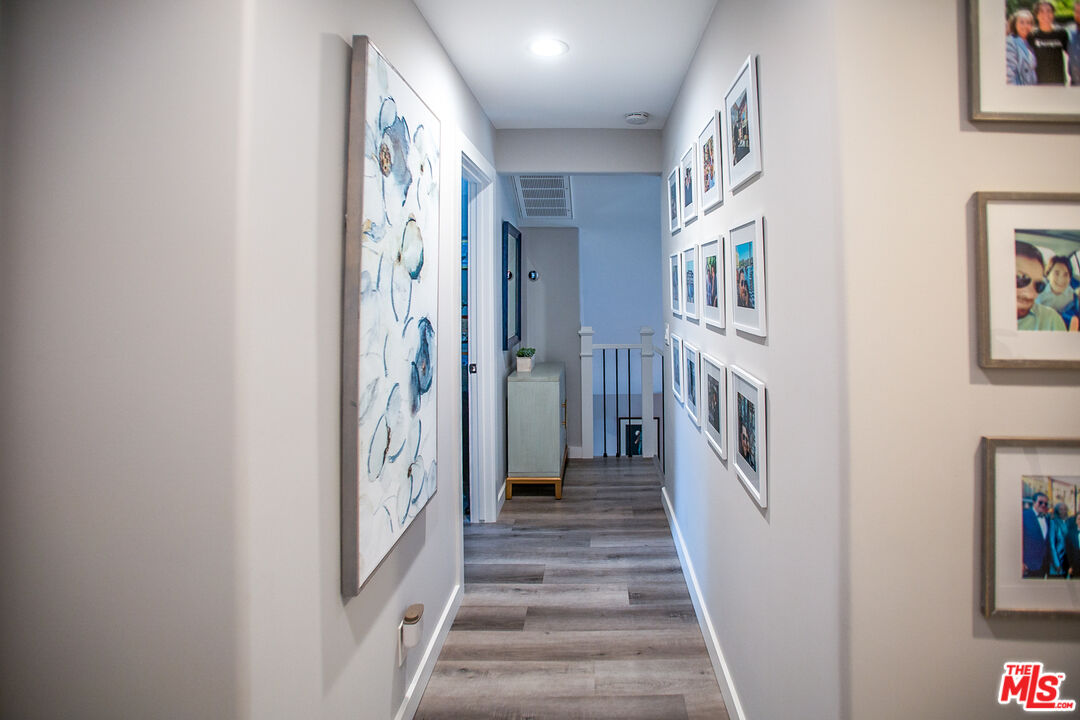 137 Main Street Los Alamos, CA 93440 - Photo 34 of 52 a view of a hallway with wooden floor and windows