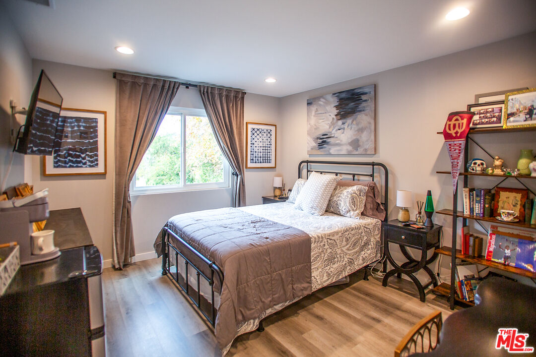 137 Main Street Los Alamos, CA 93440 - Photo 35 of 52 a bedroom with a bed a dresser and a large window