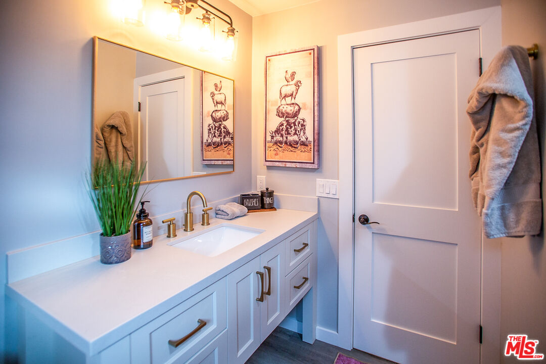 137 Main Street Los Alamos, CA 93440 - Photo 37 of 52 a bathroom with a double vanity sink a mirror and a shower