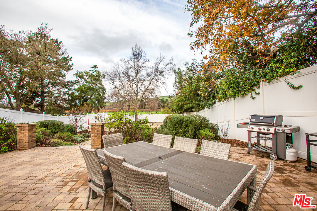 137 Main Street Los Alamos, CA 93440 - Photo 45 of 52 a view of a patio with a table and chairs under an umbrella