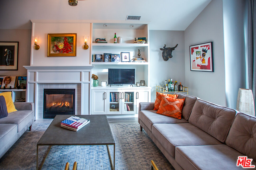 137 Main Street Los Alamos, CA 93440 - Photo 5 of 52 a living room with furniture a rug and a fireplace