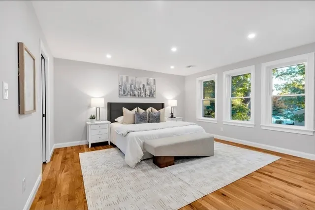 a spacious bedroom with a bed and a large window