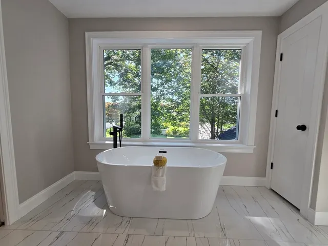 a white bath tub sitting in a bathroom