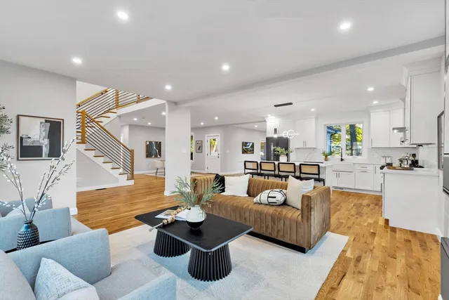 a living room with furniture kitchen view and a table