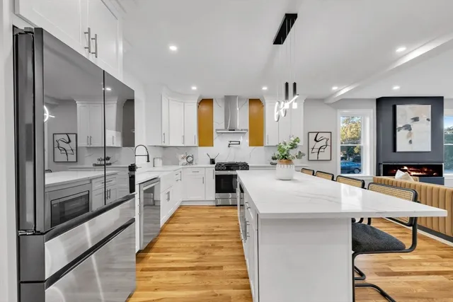 a large white kitchen with lots of counter space and windows