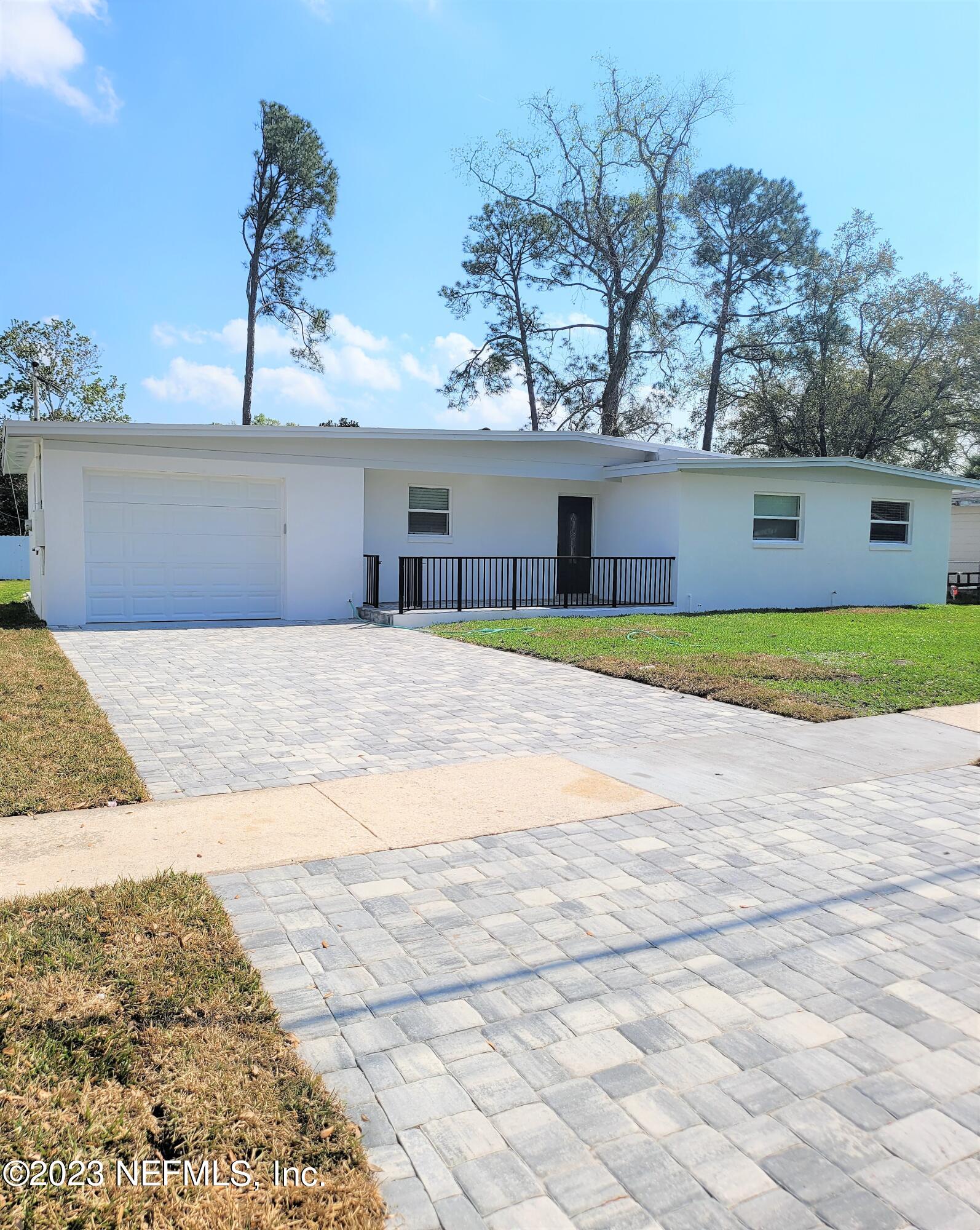 a view of a house with a yard and garage