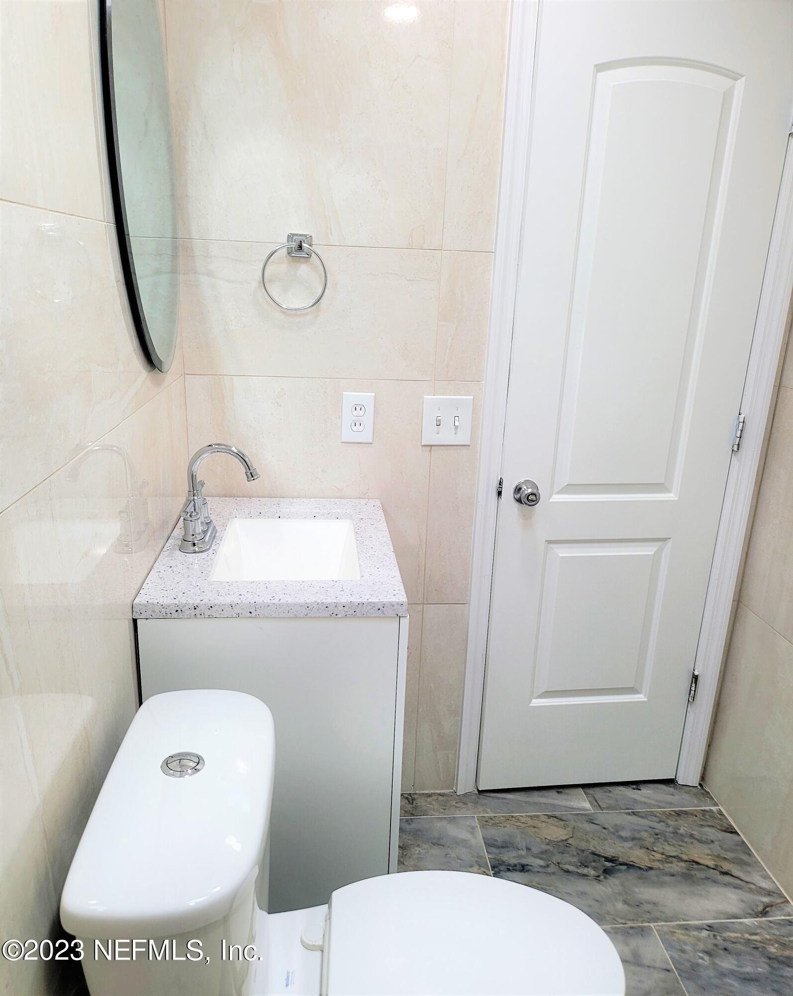 2627 Adele Road Jacksonville, FL 32216 - Photo 17 of 27 a bathroom with a toilet and a sink