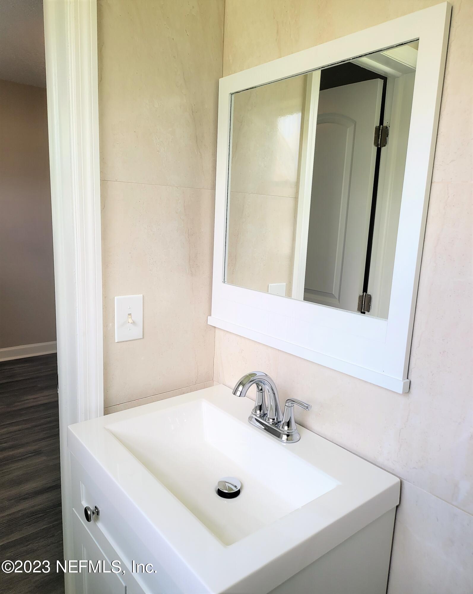 2627 Adele Road Jacksonville, FL 32216 - Photo 20 of 27 a bathroom with a sink and a mirror