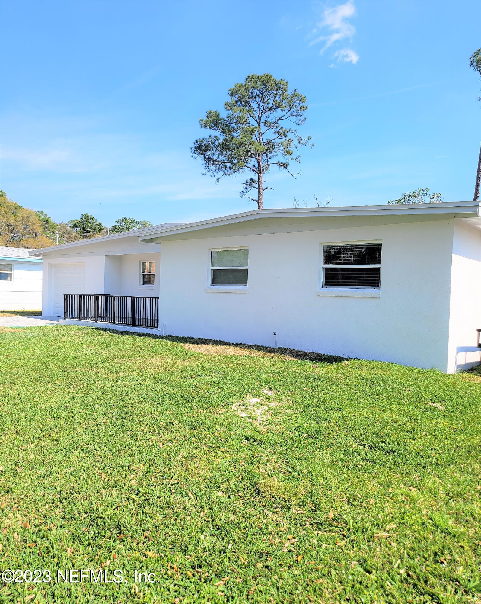 2627 Adele Road Jacksonville, FL 32216 - Photo 2 of 27 a view of a house with a garden