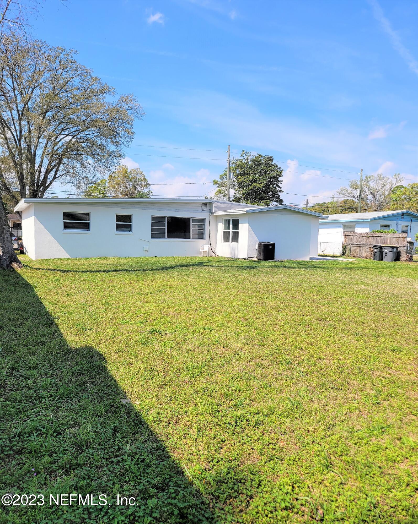 2627 Adele Road Jacksonville, FL 32216 - Photo 24 of 27 a view of a house with a big yard and potted plants