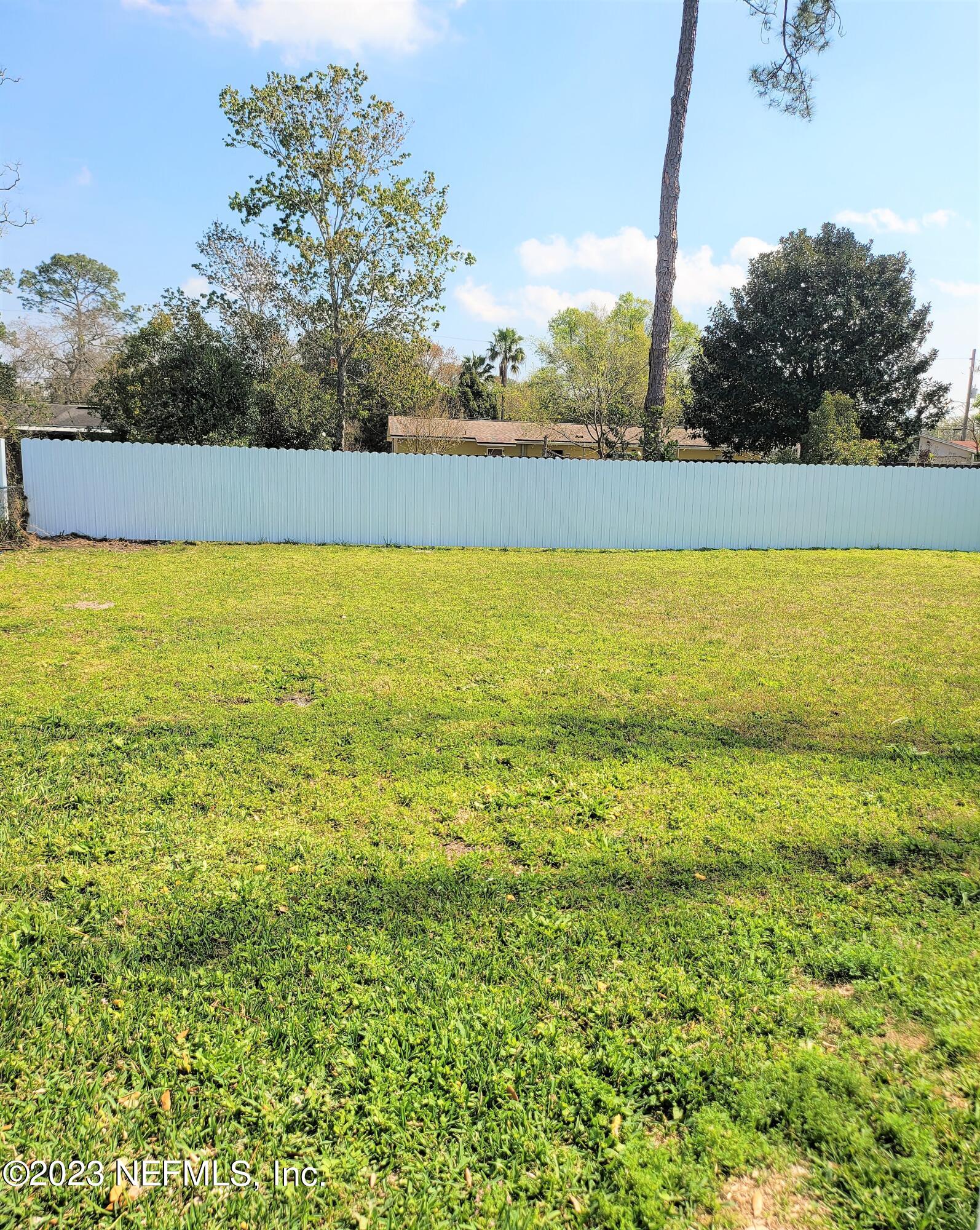 2627 Adele Road Jacksonville, FL 32216 - Photo 26 of 27 a view of yard with swimming pool and trees