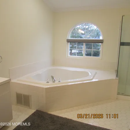 a bath tub sitting next to a window