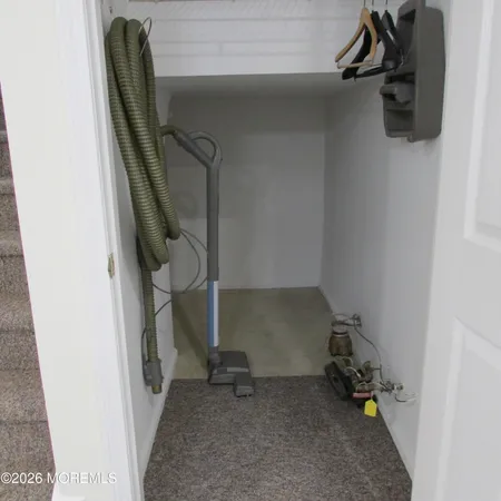 a view of a room with wooden floor and cabinets