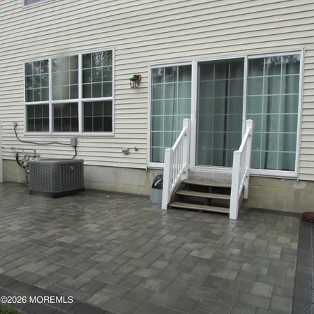 a front view of a house with a yard and a garden