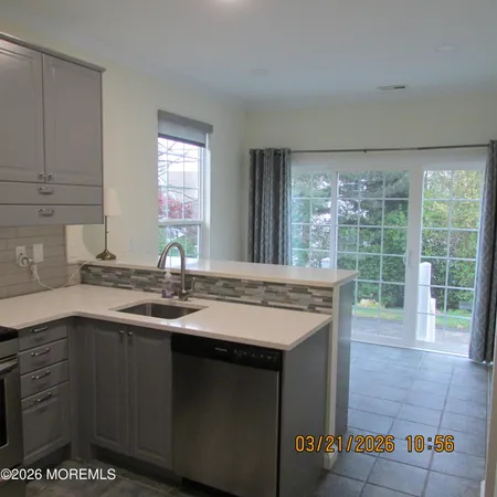 a kitchen with a sink and large window