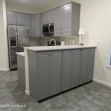 a kitchen with stainless steel appliances a sink and a refrigerator