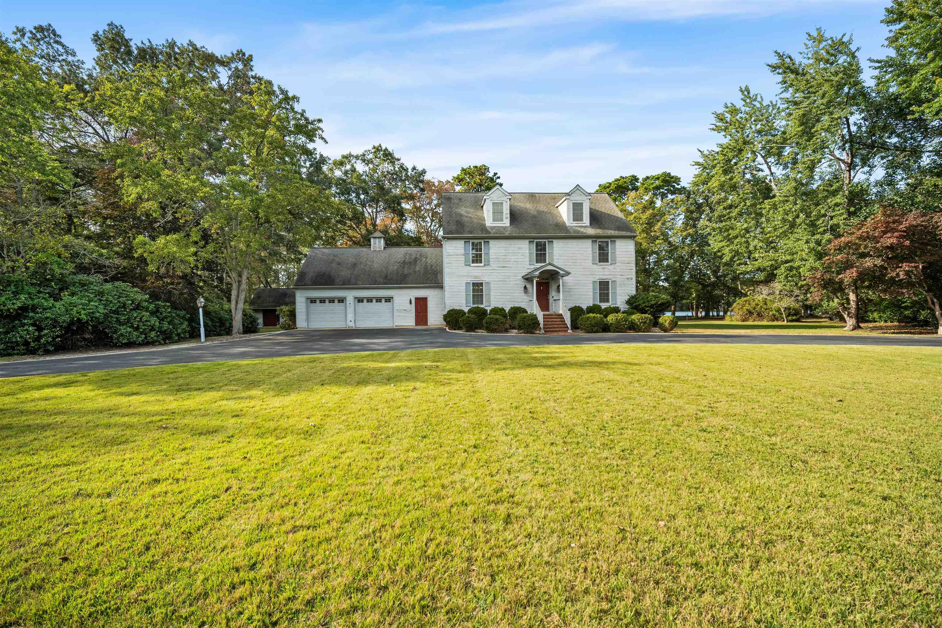 a house view with swimming pool in front of the house