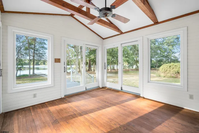 a spacious bedroom with a large bed and a large window