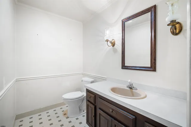 a bathroom with a sink a toilet and a mirror