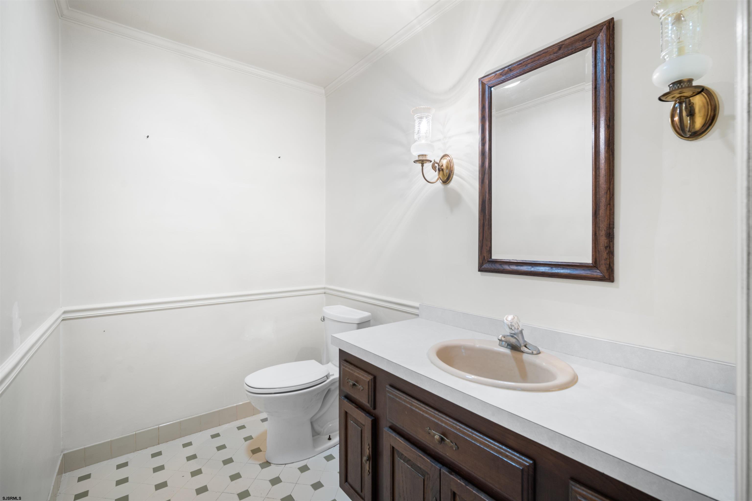 216 Riverside Drive Port Republic, NJ 08241 - Photo 17 of 47 a bathroom with a sink a toilet and a mirror