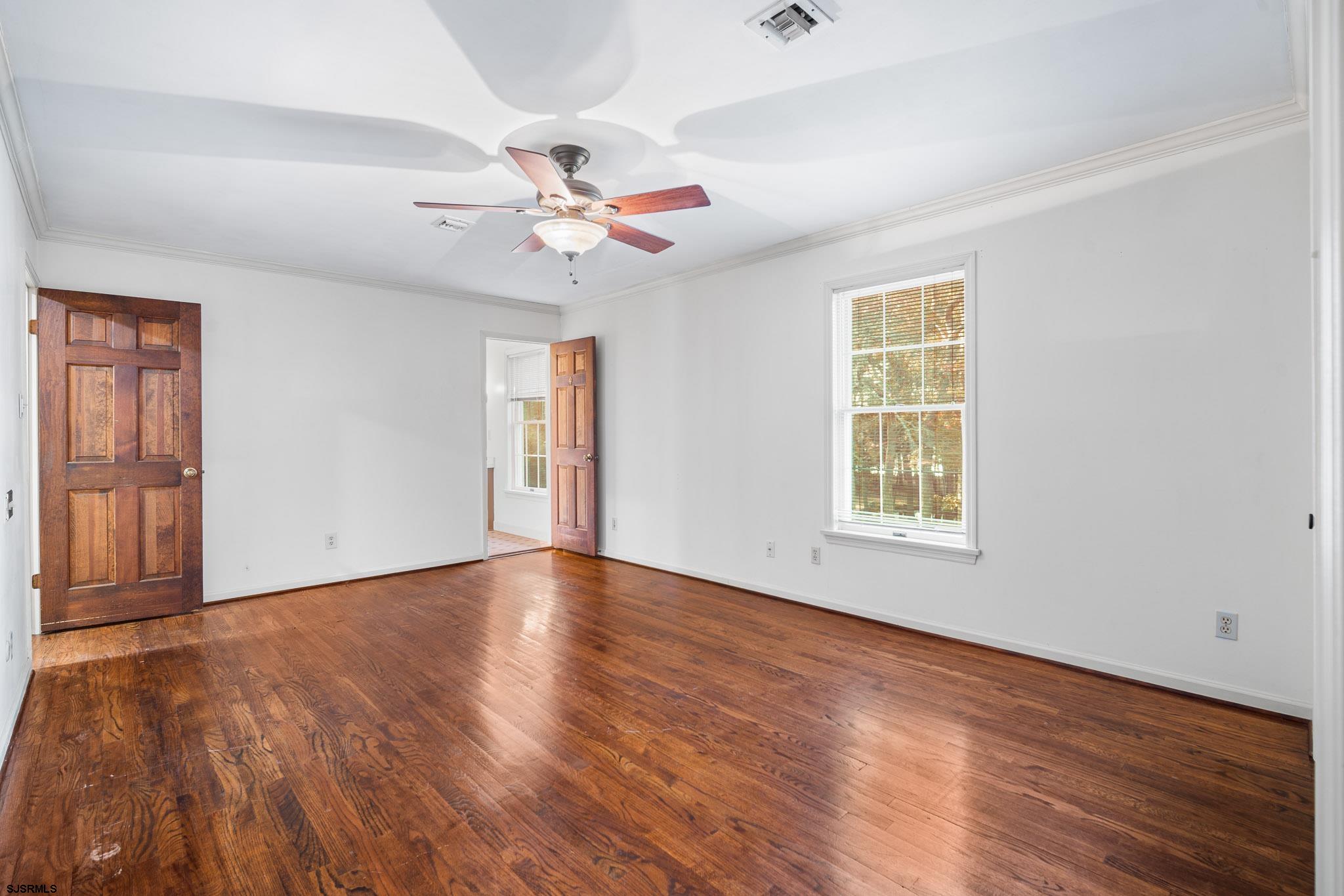 216 Riverside Drive Port Republic, NJ 08241 - Photo 22 of 47 wooden floor in an empty room with a window